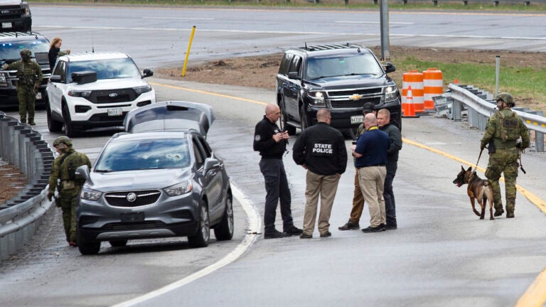 Members of law enforcement investigate a scene where people were injured in a shooting on Interstate 295, in Yarmouth, Maine.
