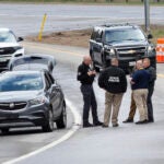 Members of law enforcement investigate the scene where people were injured in a shooting on Interstate 295 in Yarmouth, Maine, on Tuesday.