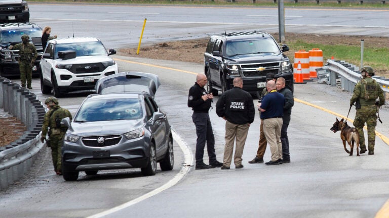 Members of law enforcement investigate the scene where people were injured in a shooting on Interstate 295 in Yarmouth, Maine, on Tuesday.