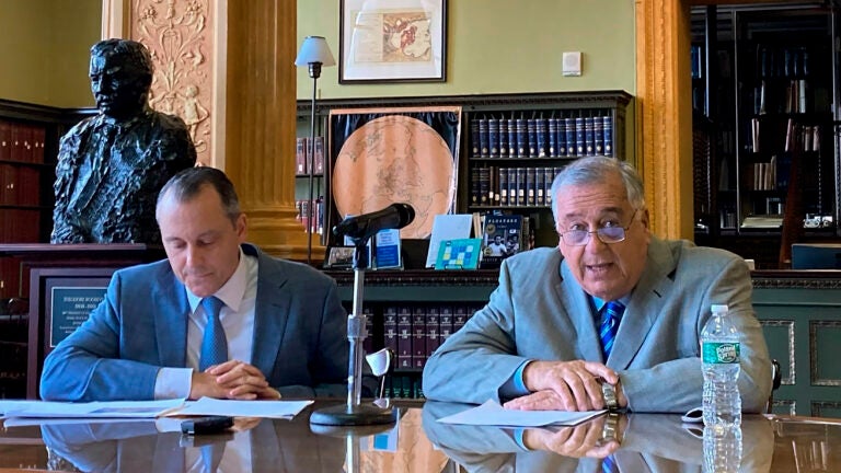 Massachusetts House Ways and Means Chair Aaron Michlewitz, left, and House Speaker Ronald Mariano, right, face reporters during a news conference, Wednesday, April 12, 2023, as they discuss details of the Massachusetts House's proposed version of the state's 2024 fiscal year budget.
