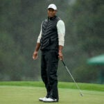 Tiger Woods standing in the rain.