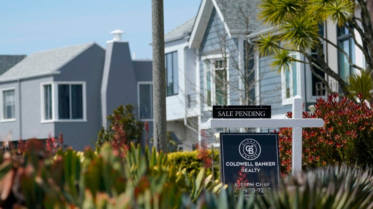 A home with a sale pending sign is used to illustrate a story on mortgage rates.