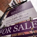 a for sale sign on a brick building is used to illustrate the weekly mortgage rate average.