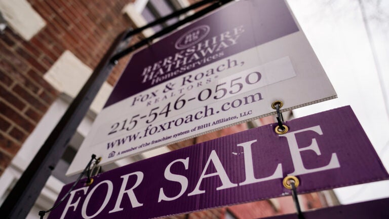 a for sale sign on a brick building is used to illustrate the weekly mortgage rate average.
