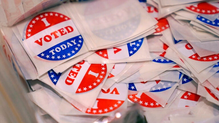 A bin of "I Voted Today" stickers rests on a table at a polling place in Stratham, N.H.