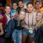 Seven smiling people celebrate the Pride Bar Crawl in Boston