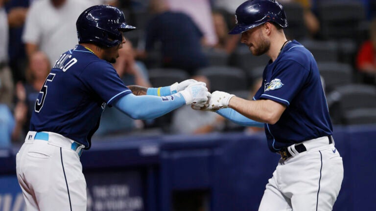 Red Sox -- Rays' Brandon Lowe, right, celebrates with Wander Franco