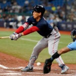 Red Sox outfielder Masataka Yoshida swings and misses against the Rays.