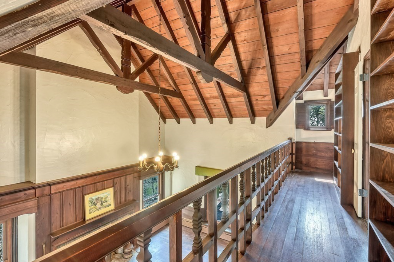 Loft with vaulted exposed wood ceiling beams. 