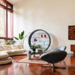 Living room with floor-to-ceiling windows, cream walls, and hardwood floors.