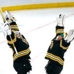 Boston Bruins goaltender Linus Ullmark, left, celebrates with Jeremy Swayman, right, after defeating the Ottawa Senators 2-1 following an NHL hockey game, Tuesday, March 21, 2023, in Boston.
