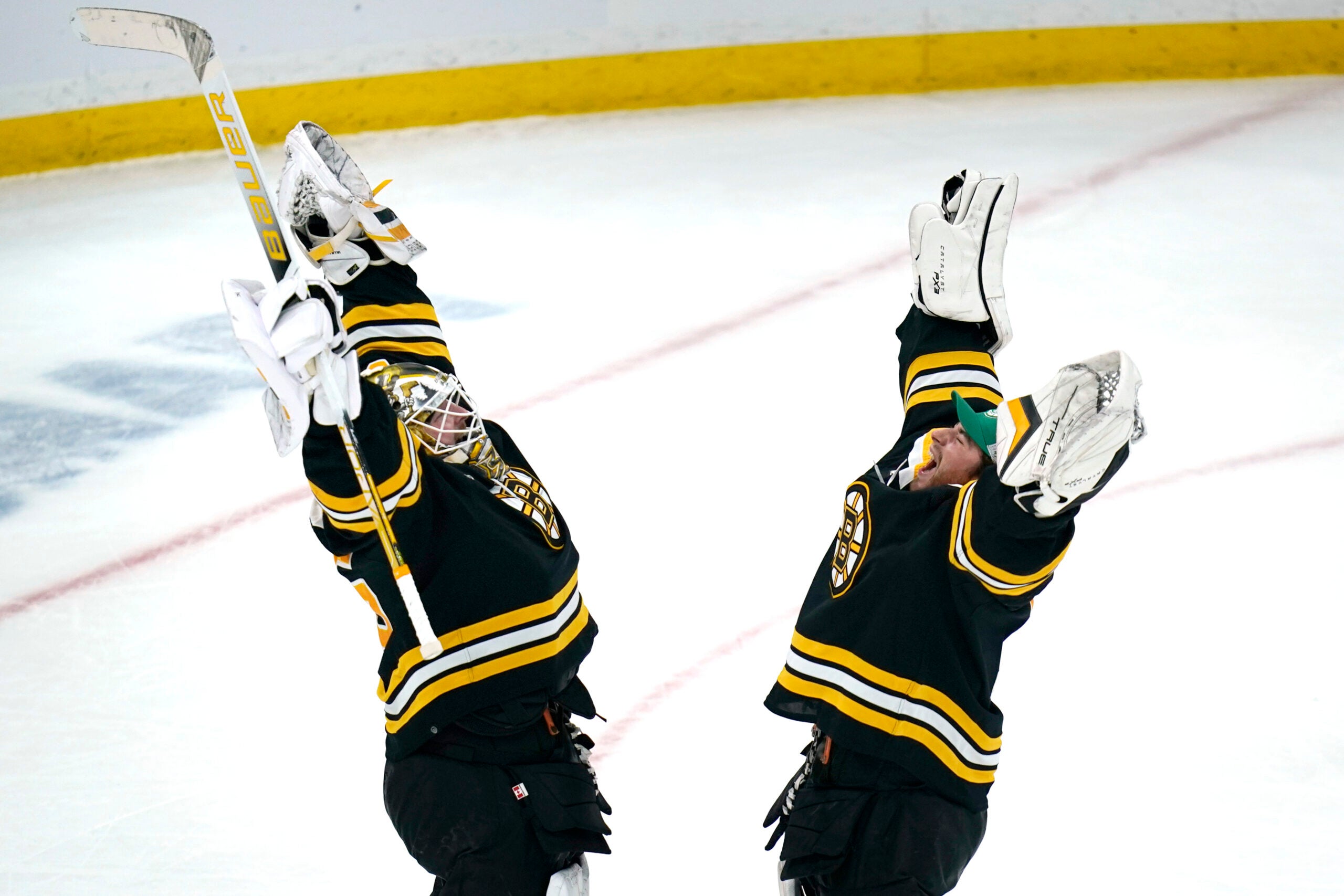 Boston Bruins goaltender Linus Ullmark, left, celebrates with Jeremy Swayman, right, after defeating the Ottawa Senators 2-1 following an NHL hockey game, Tuesday, March 21, 2023, in Boston.