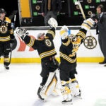 Boston, MA - 4/8/2023 - 09BRUINS-DEVILS - (3rd period) Boston Bruins goaltender Jeremy Swayman (1) and Boston Bruins goaltender Linus Ullmark (35) celebrate the win. The Boston Bruins host the New Jersey Devils on April 8, 2023 at TD Garden in Boston, MA.