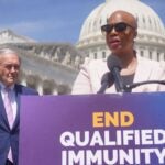 Rep. Ayanna Pressley and Sen. Ed Markey stand behind a podium.
