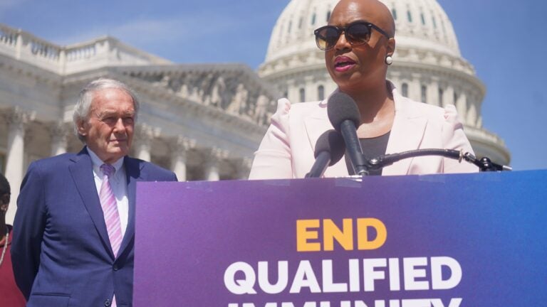 Rep. Ayanna Pressley and Sen. Ed Markey stand behind a podium.