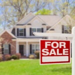 Home prices. Home For Sale Real Estate Sign and Beautiful New House.