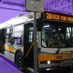Free fare MBTA bus with the words 'ride for free' on the LED sign. Background is tinted purple.