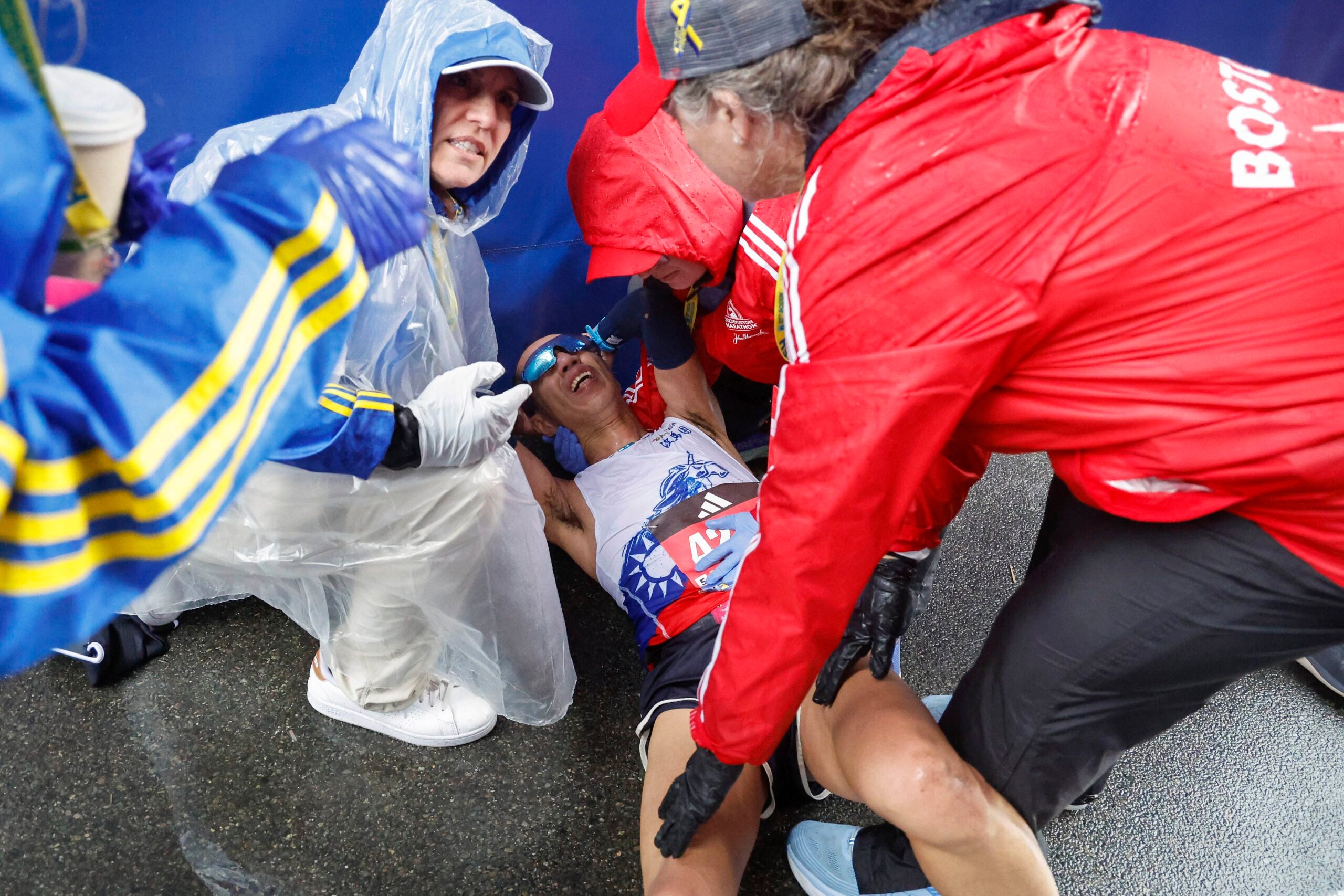 Hsuanhsu Su of Taiwan is attended to by medical personel after collapsing after crossing the finish line of the 127th Boston Marathon Monday, April 17, 2023, in Boston.