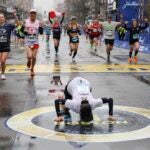 Maria Correia of Brazil kisses the ground after crossing the finish line of the127th Boston Marathon Monday, April 17, 2023, in Boston.