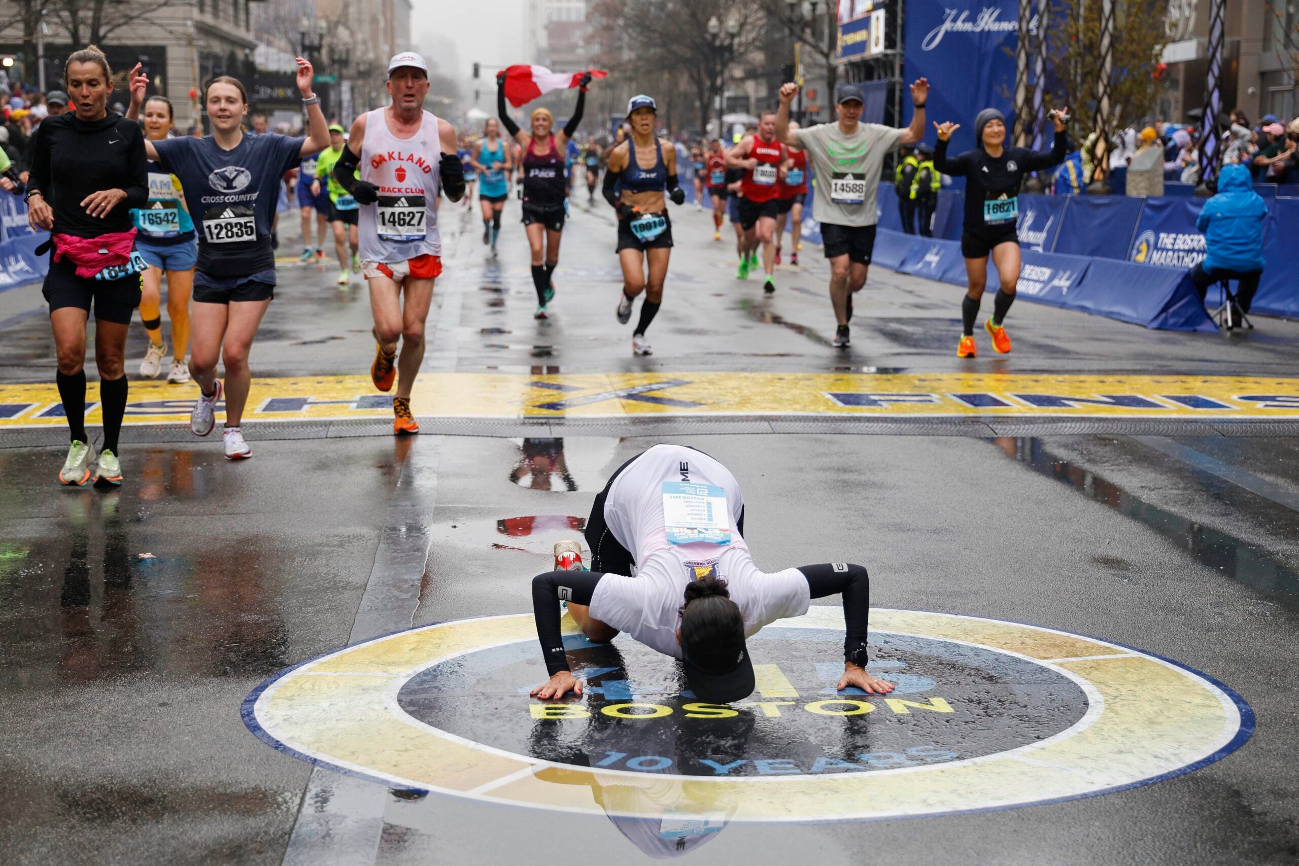 Maria Correia of Brazil kisses the ground after crossing the finish line of the127th Boston Marathon Monday, April 17, 2023, in Boston.