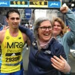 Denise Richard hugs her son Henry(left) as Henry’s sister Jane(right) cries as she hugs an MR8 runner at the finish line.