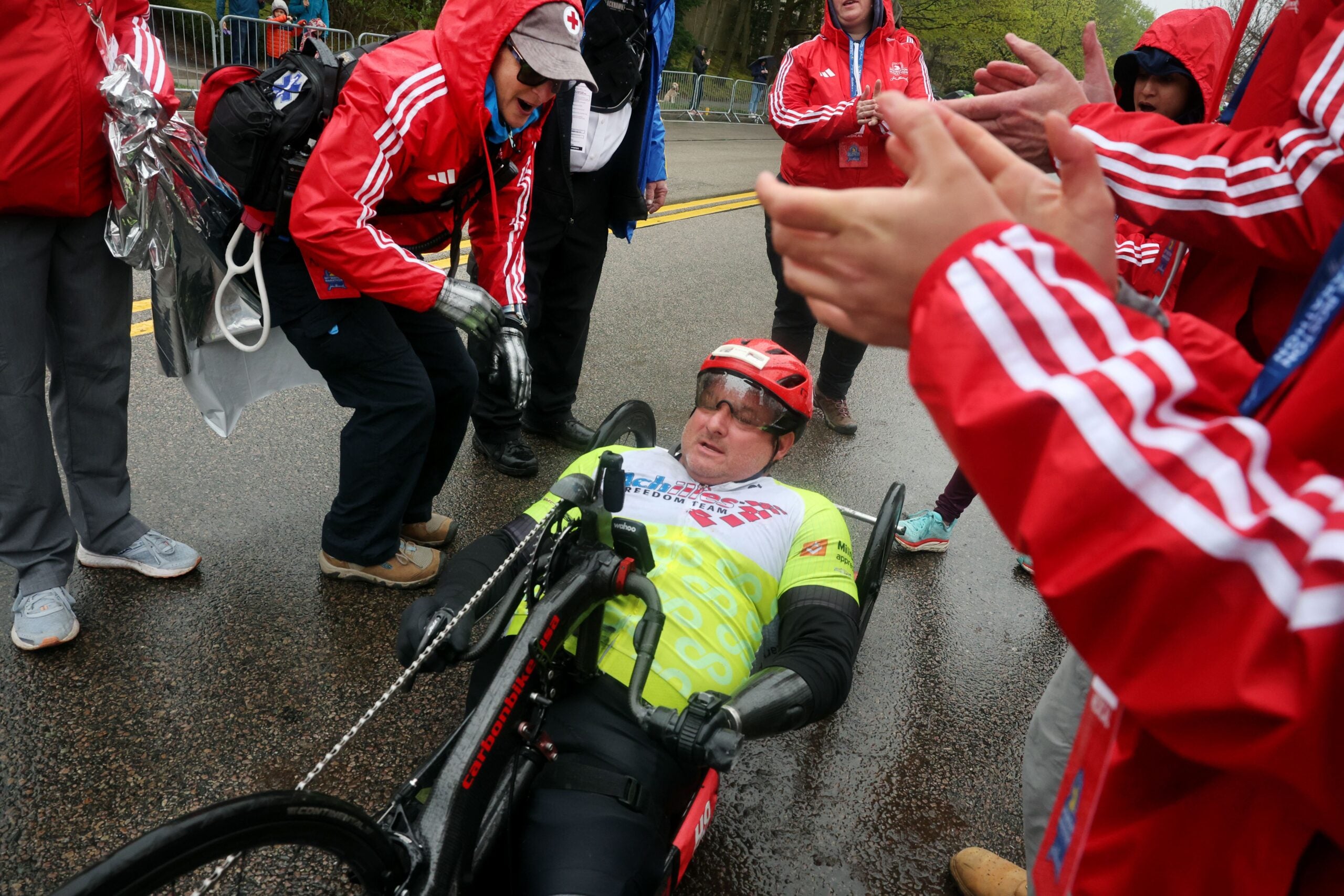 Handcyclist John Masson departs after getting help with his chain at Heartbreak Hill during the running of the 127th Boston Marathon in Newton, MA on April 17, 2023. 