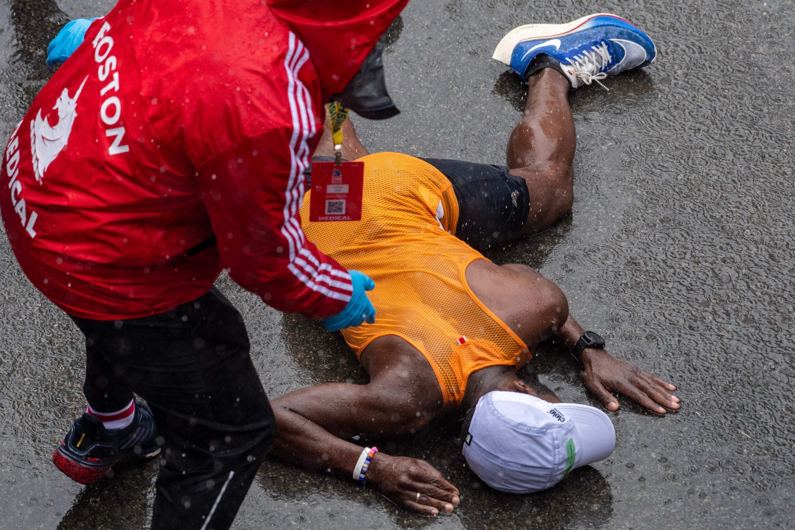 A runner collapses at the finish line during the 127th Boston Marathon in Boston, Massachusetts on April 17, 2023.