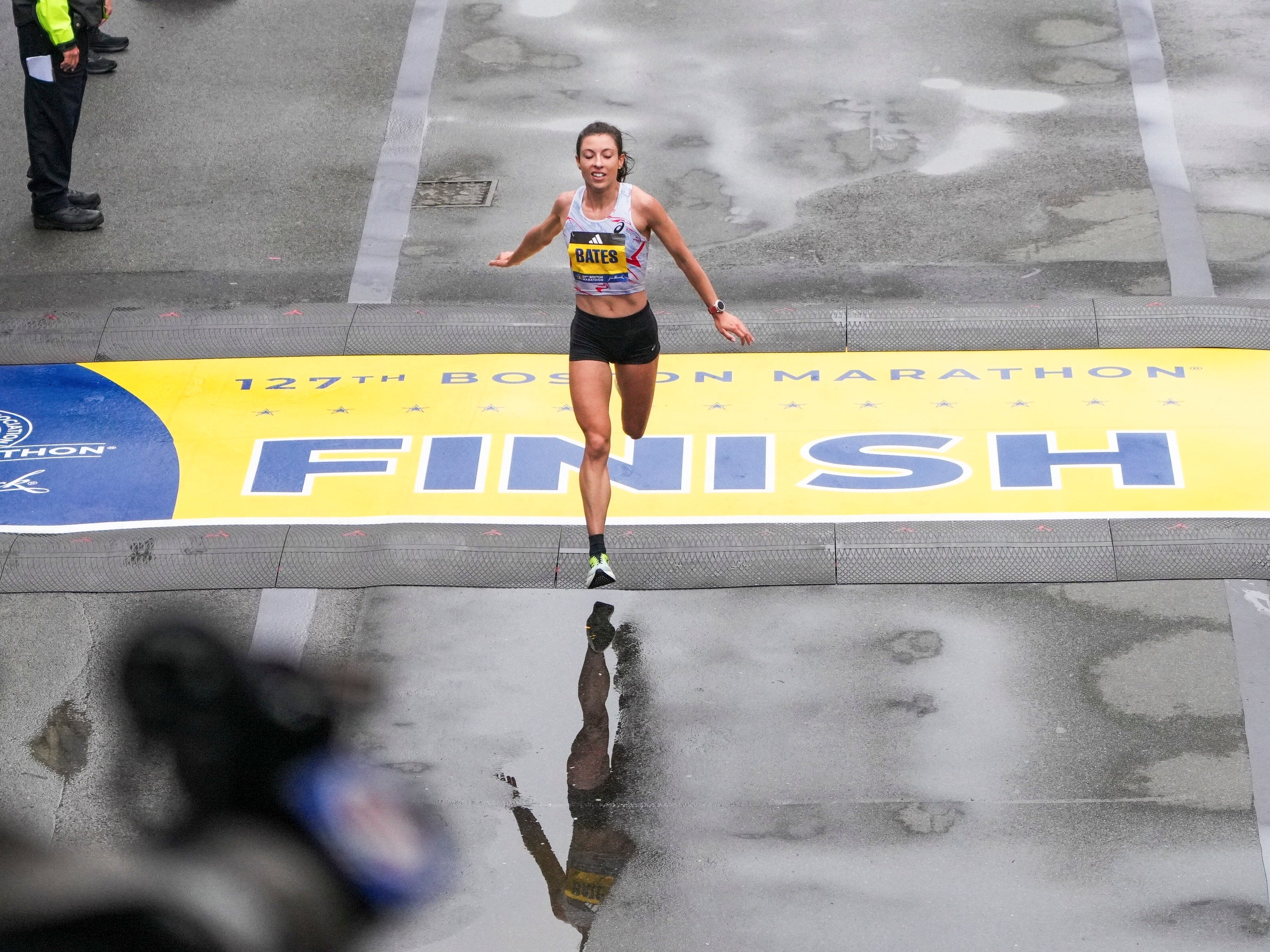 Emma Bates crossing the finish line.