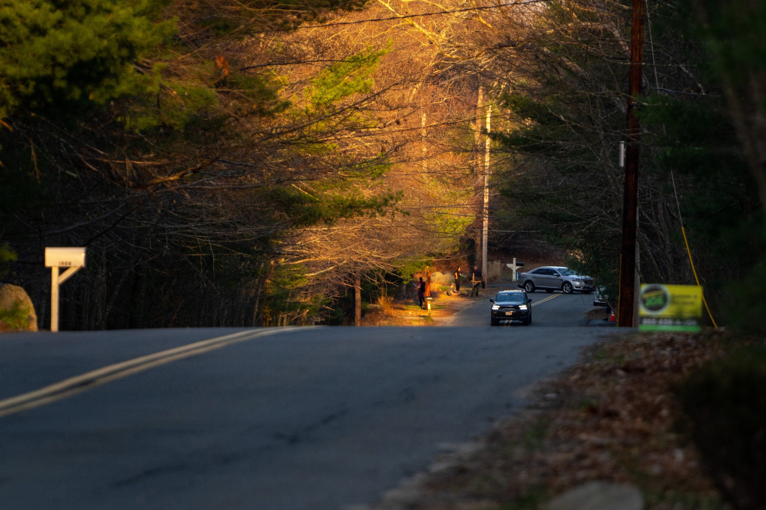 A police car is seen driving near the house where Jack Teixeira, a member of the Air National Guard, was arrested for sharing classified documents.