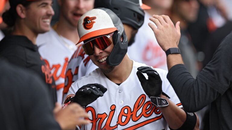 Ramon Urias #29 of the Baltimore Orioles celebrates with teammates after scoring during the eighth inning against the Boston Red Sox.