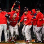 Boston Red Sox right fielder Alex Verdugo (99) and teammates celebrate after his game winning walkoff single in the tenth inning was ruled a fair ball after review. The Boston Red Sox host the Minnesota Twins on April 18, 2023 at Fenway Park in Boston, MA.