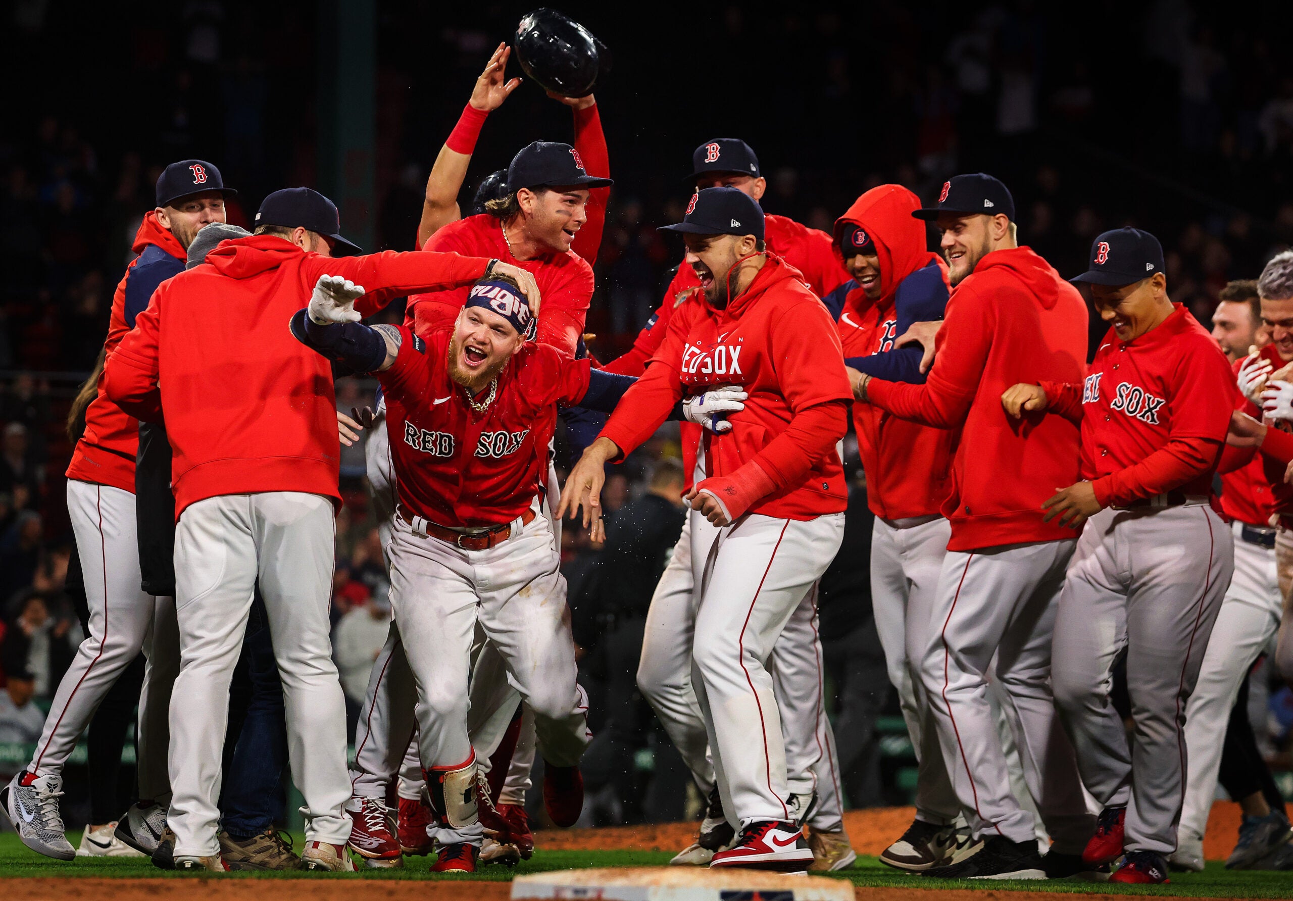Boston Red Sox right fielder Alex Verdugo (99) and teammates celebrate after his game winning walkoff single in the tenth inning was ruled a fair ball after review. The Boston Red Sox host the Minnesota Twins on April 18, 2023 at Fenway Park in Boston, MA.