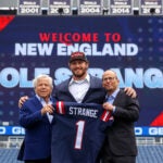 Cole Strange is the most recent first round pick made by Bill Belichick and the Patriots. He stands alongside Robert and Jonathan Kraft at Gillette Stadium.