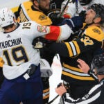 Boston Bruins center Patrice Bergeron (37) and Florida Panthers left wing Matthew Tkachuk (19) getting physical in front of the Bruins net during first period NHL action at the TD Garden
