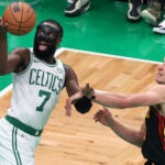 Jaylen Brown is fouled by the Hawks Bogdan Bogdanovic as he drives to the basket in the second half on Tuesday.