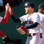 Justin Turner, Alex Verdugo, and Rafael Devers high five after Sunday's Red Sox win