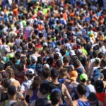 A wave of runners start the 2022 Boston Marathon.