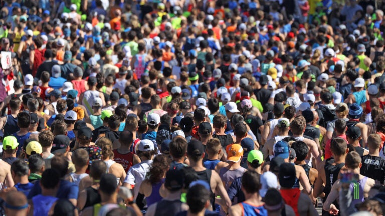 A wave of runners start the 2022 Boston Marathon.