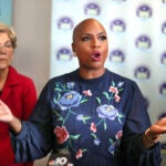Ayanna Pressley speaks to an audience as Elizabeth Warren stands to her left