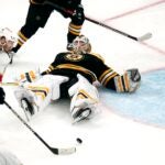 Bruins goaltender Linus Ullmark lays on his back on the ice.