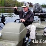 Amateur fisherman Jim Thames uses a fish-finding sonar system to look for bass in the Charles River.