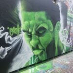 A mural of Jayson Tatum painted green in Cambridge.