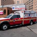 An ambulance leaves the entrance to Elmhurst Hospital Center, which witnessed some of the highest number of Covid-19 cases and deaths on May 11, 2023 in the Queens borough of New York City.