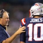Head coach Bill Belichick of the New England Patriots talks to Mac Jones #10 against the Philadelphia Eagles in the first half of the preseason game at Lincoln Financial Field on August 19, 2021 in Philadelphia, Pennsylvania. The Patriots defeated the Eagles 35-0. (Photo by Mitchell Leff/Getty Images)