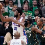 Philadelphia 76ers center Joel Embiid (21) is pressured by Boston Celtics guard Jaylen Brown.