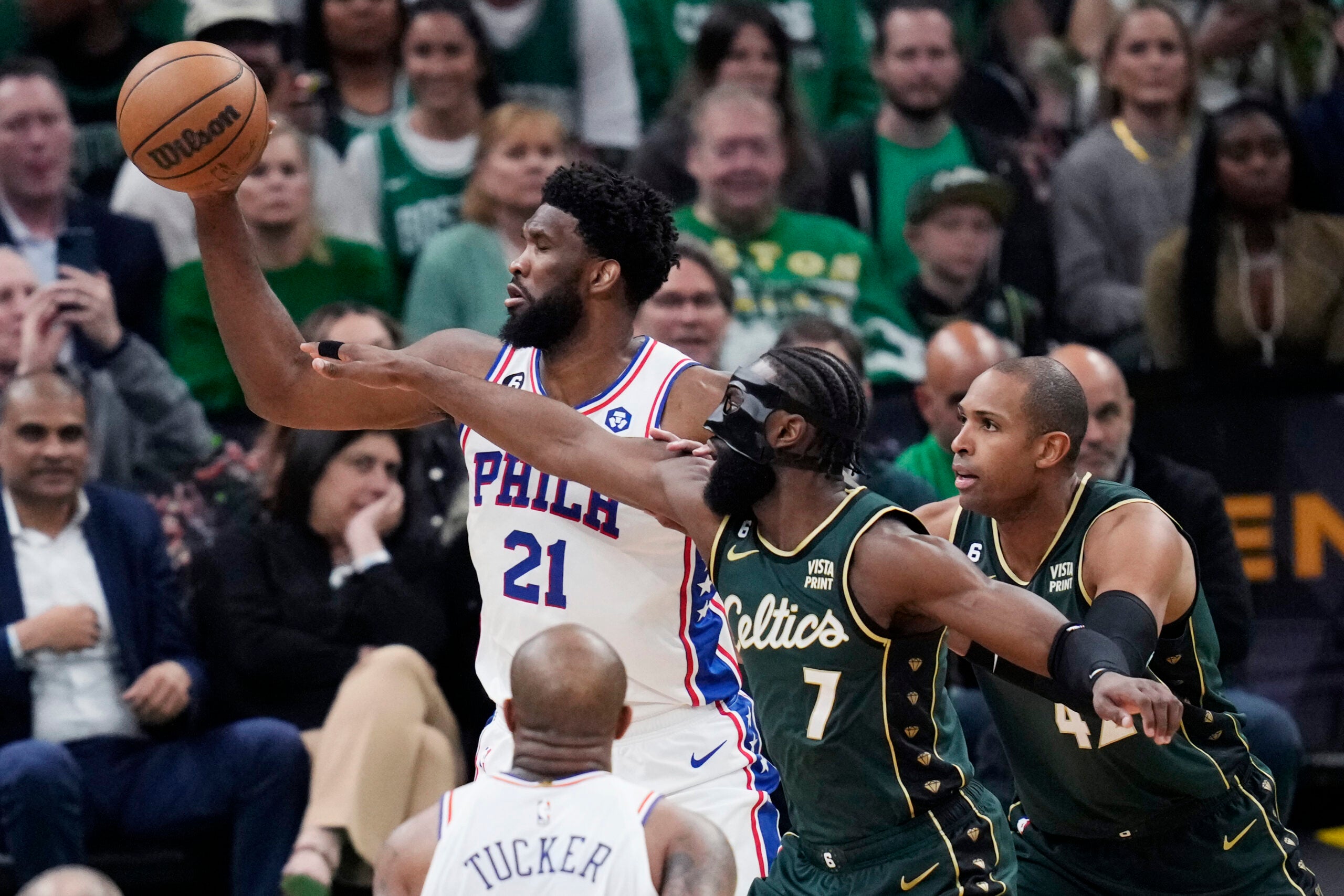 Philadelphia 76ers center Joel Embiid (21) is pressured by Boston Celtics guard Jaylen Brown.