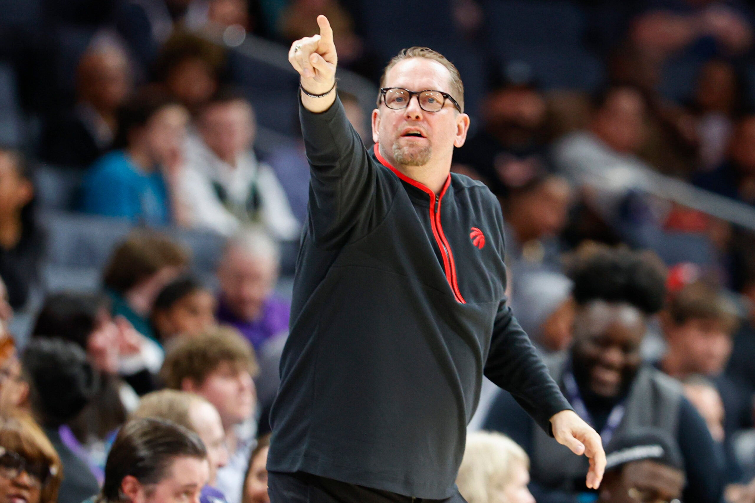 Toronto Raptors head coach Nick Nurse directs his team during the first half of an NBA basketball game against the Charlotte Hornets.
