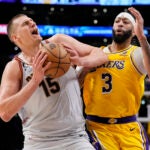 Denver Nuggets center Nikola Jokic (15) is defended by Los Angeles Lakers forward Anthony Davis (3) in the second half of Game 4 of the NBA basketball Western Conference Finals.
