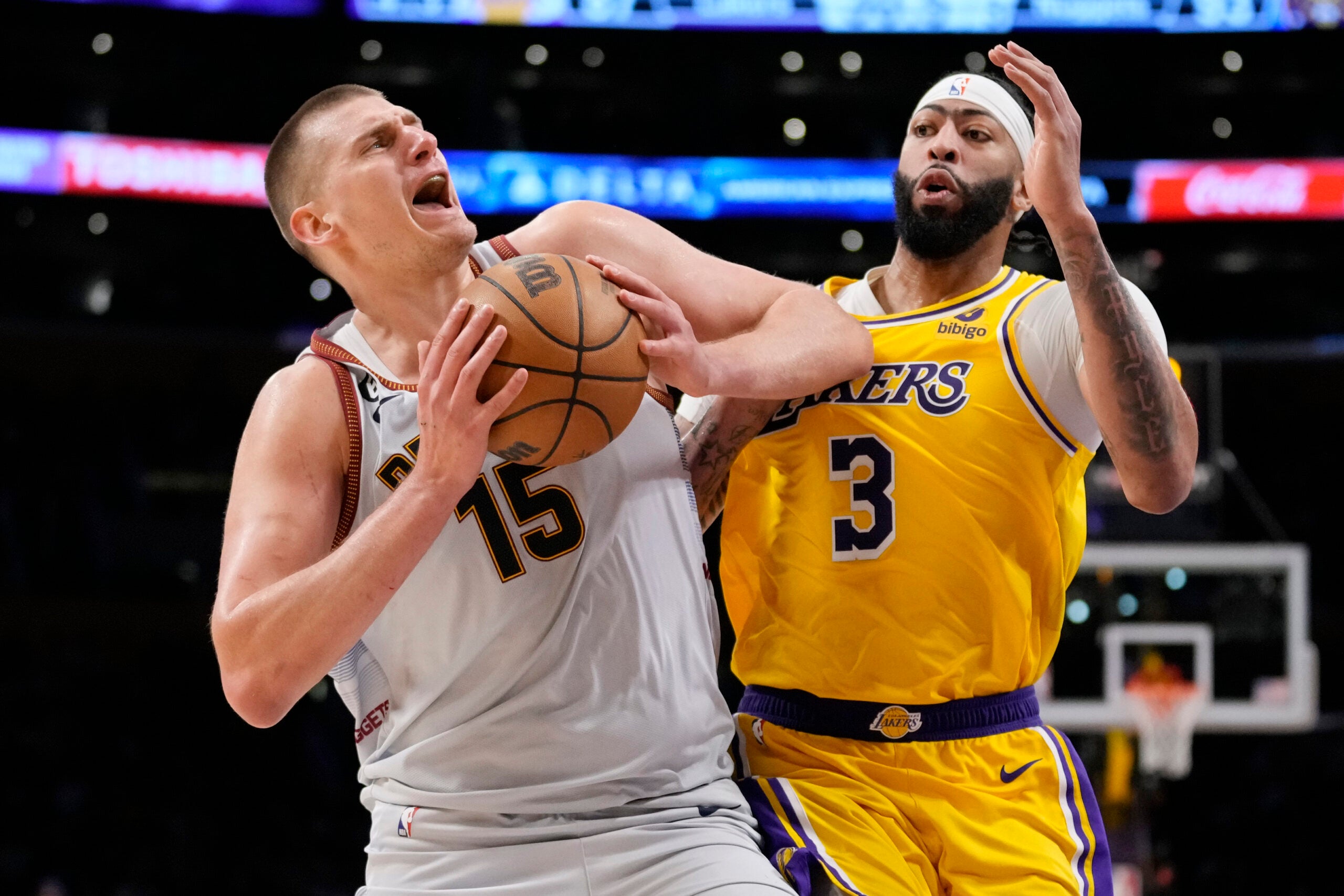 Denver Nuggets center Nikola Jokic (15) is defended by Los Angeles Lakers forward Anthony Davis (3) in the second half of Game 4 of the NBA basketball Western Conference Finals.