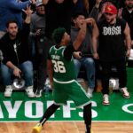 Marcus Smart celebrates near the sideline after hitting a three for the Celtics.